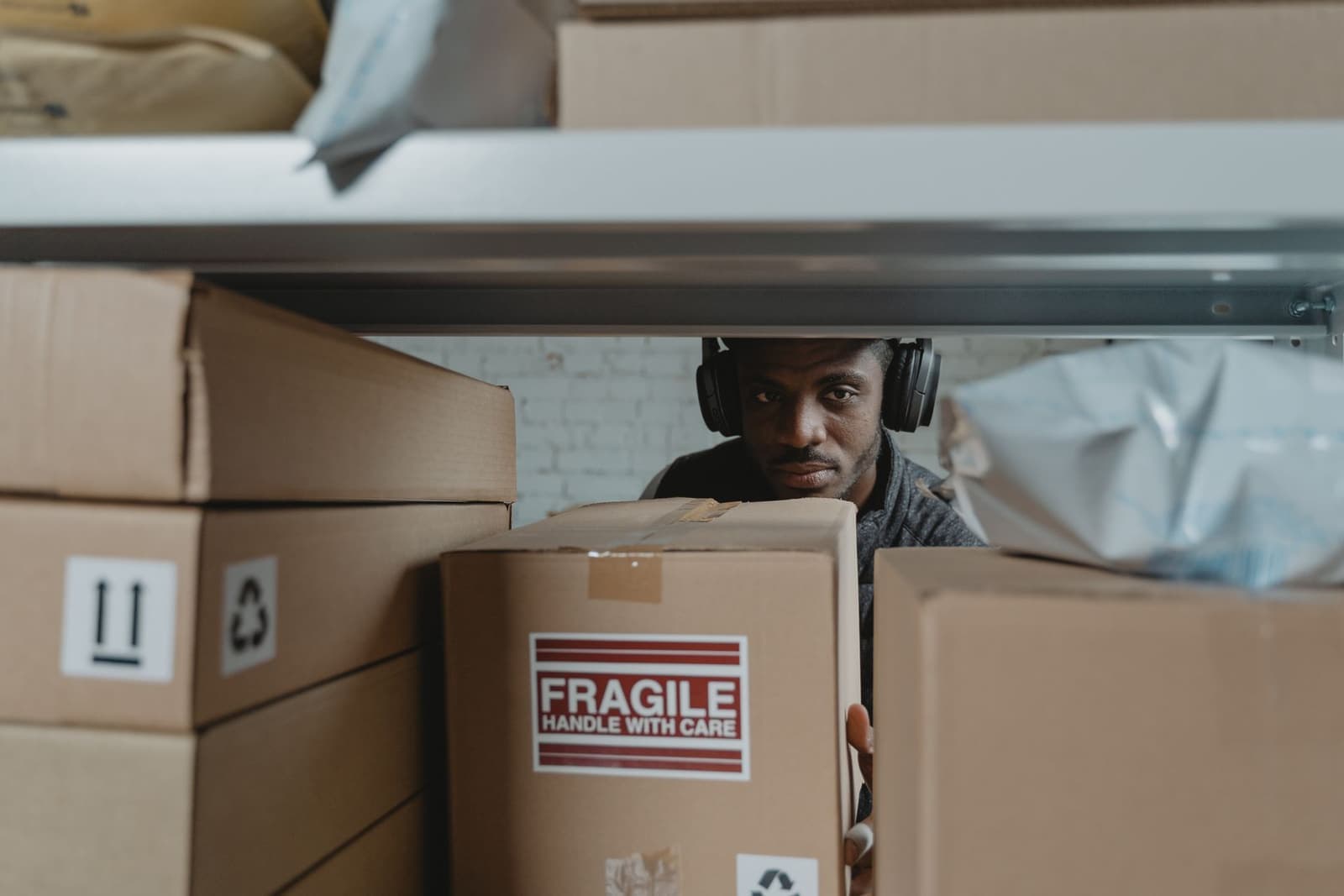 Operator packing a fragile parcel in a warehouse